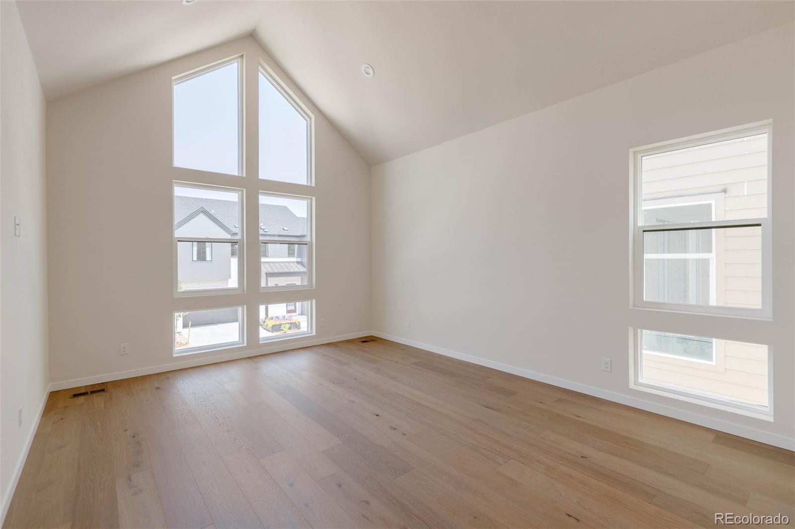 11468 Alla Breve Lone Tree, CO 80134 - Photo 21 of 34 an empty room with wooden floor and windows