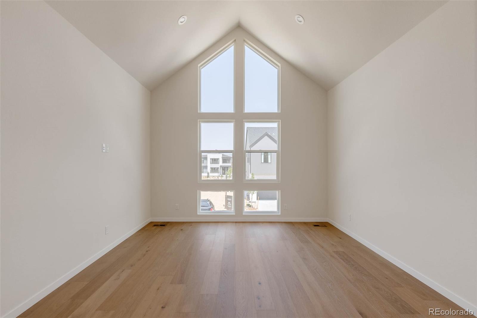 11468 Alla Breve Lone Tree, CO 80134 - Photo 22 of 34 an empty room with wooden floor and windows