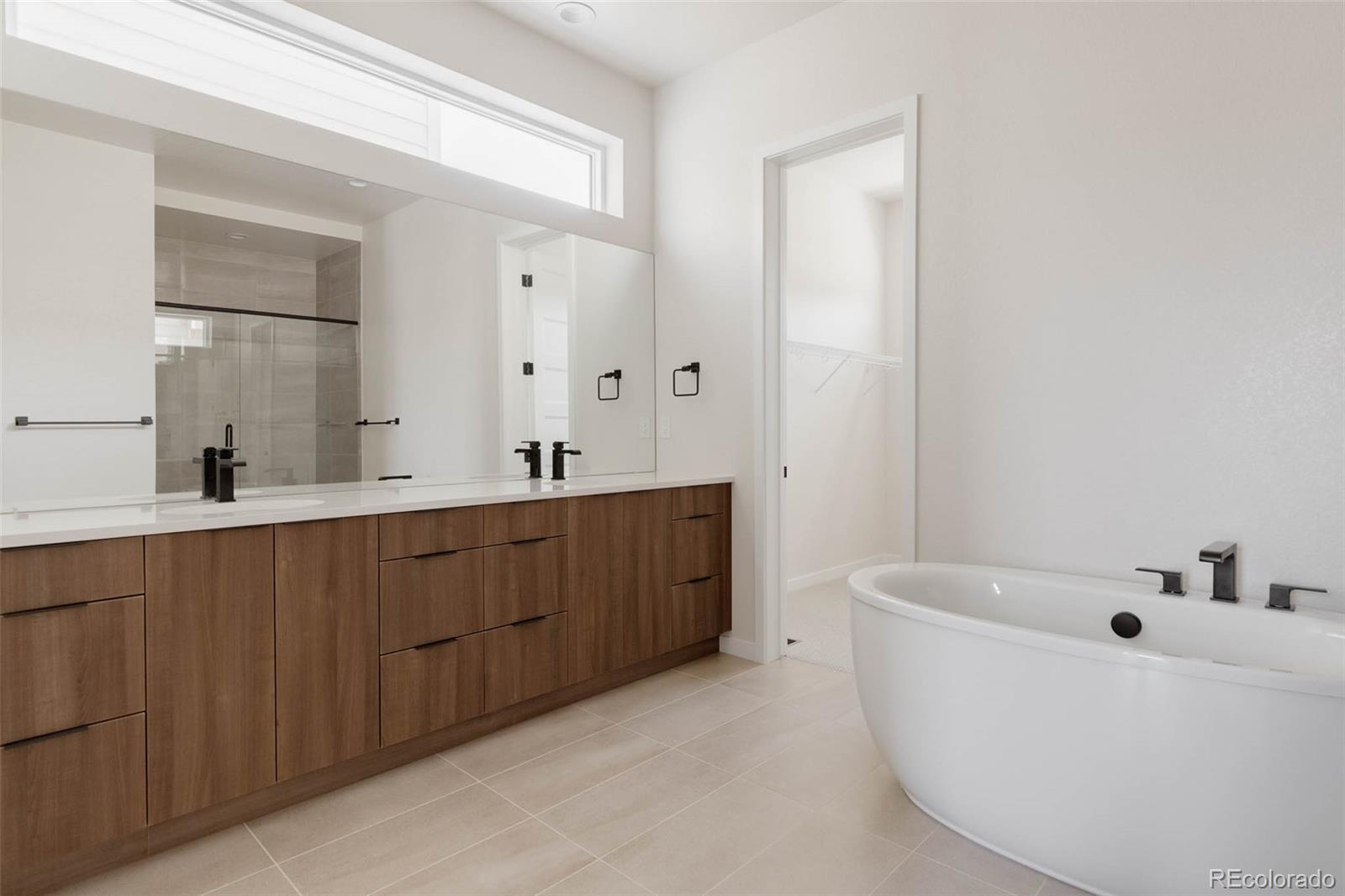 11468 Alla Breve Lone Tree, CO 80134 - Photo 23 of 34 a bathroom with a tub sink and mirror