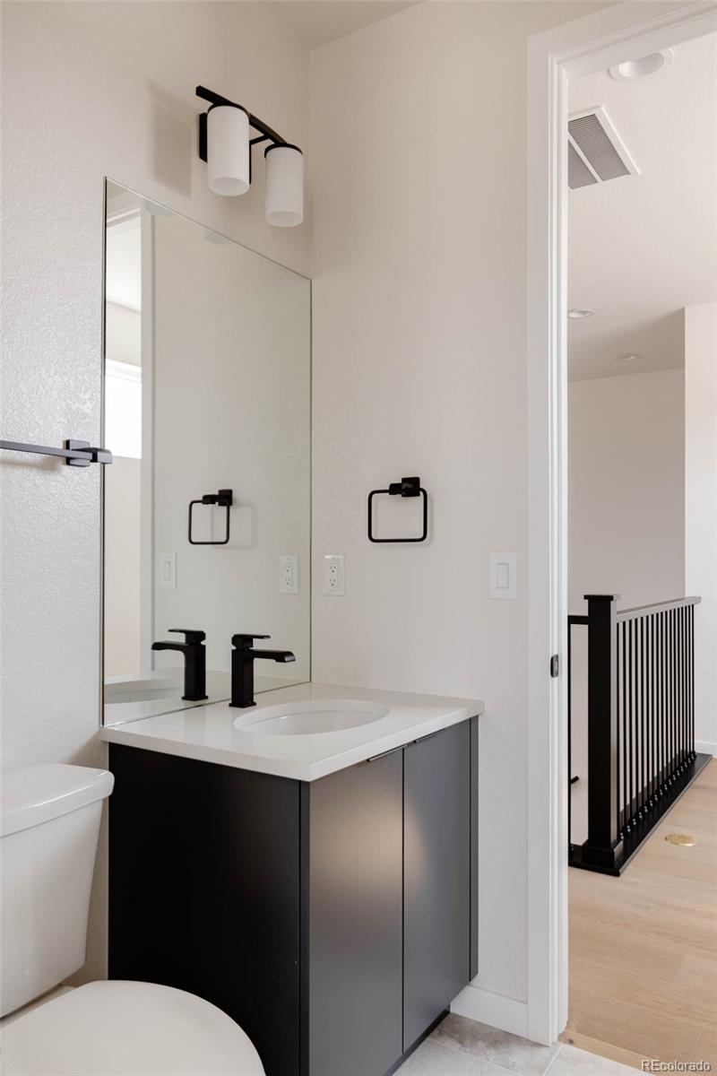 11468 Alla Breve Lone Tree, CO 80134 - Photo 32 of 34 a bathroom with a sink toilet and shower
