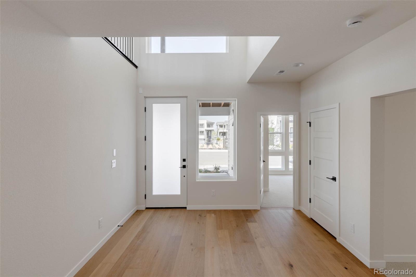 11468 Alla Breve Lone Tree, CO 80134 - Photo 4 of 34 a view of an empty room with wooden floor and a window