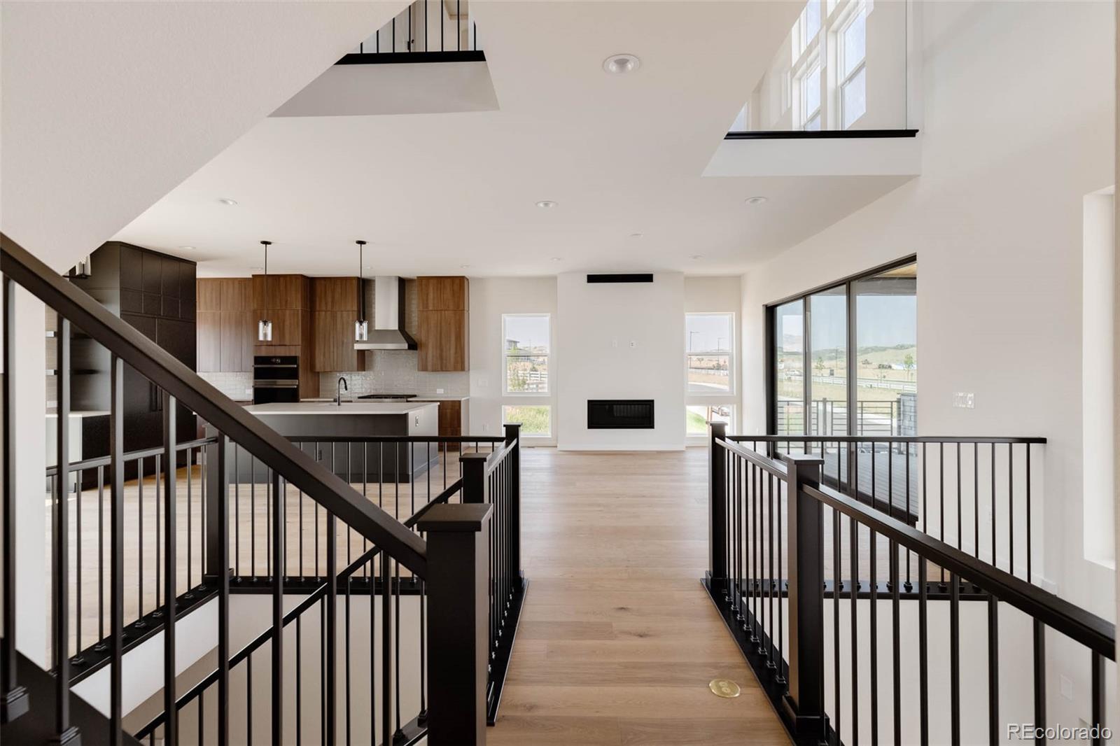 11468 Alla Breve Lone Tree, CO 80134 - Photo 8 of 34 a view of a hallway with wooden floor and staircase