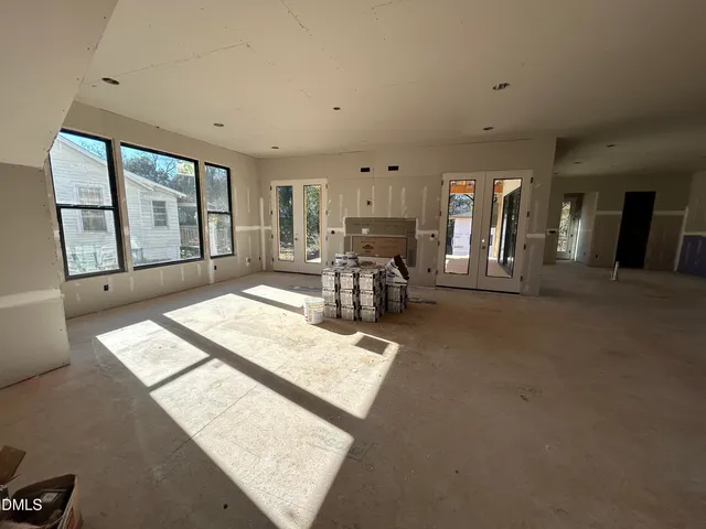 a living room with furniture and large windows