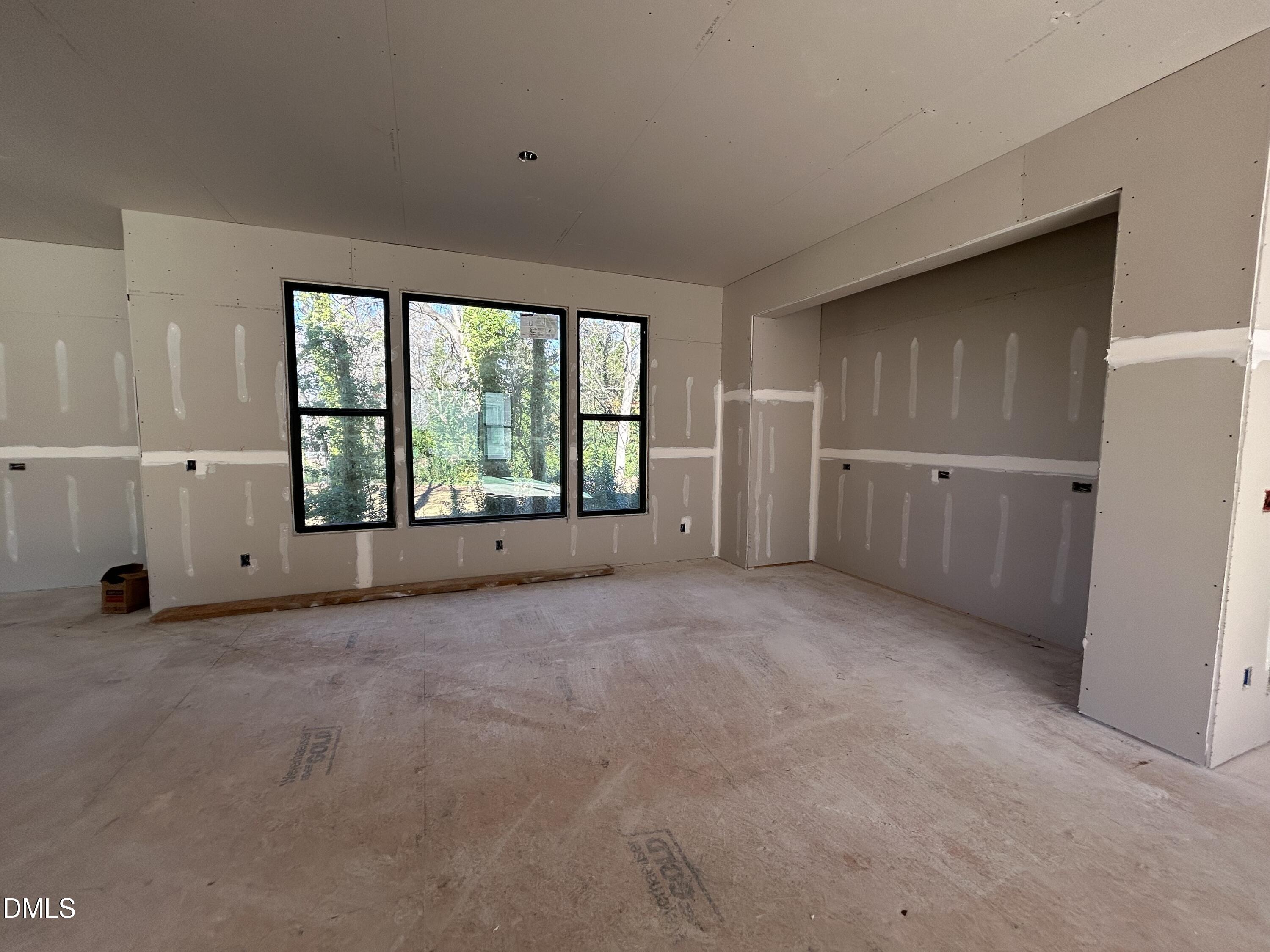909 Oberlin Road Raleigh, NC 27605 - Photo 3 of 10 an empty room with chandelier fan and windows
