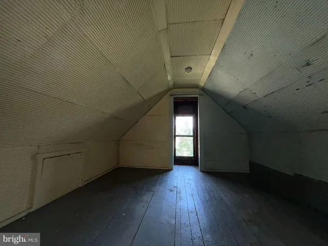 a view of a livingroom with wooden floor and window