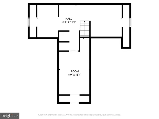 a picture of a bench in room with a white wall