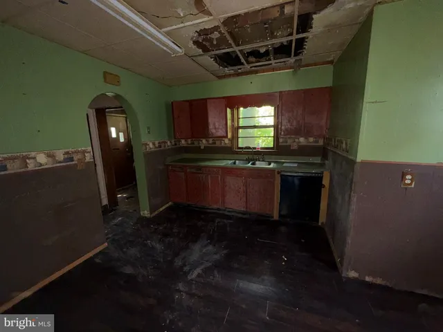 a kitchen with stainless steel appliances granite countertop a sink a stove microwave and refrigerator