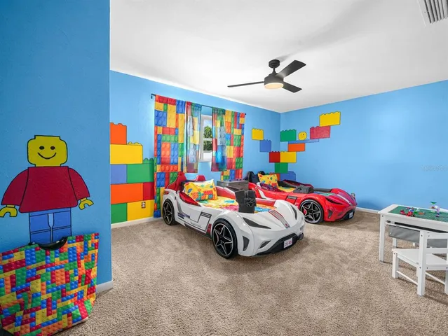 a bedroom with a bed and a flat tv screen