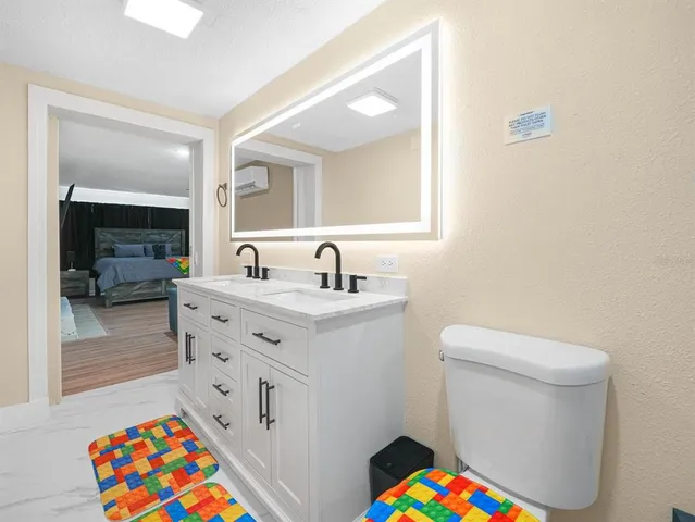 a bedroom with a bed and a ceiling fan