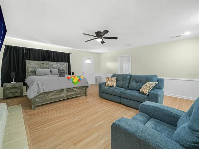 a bed room with a bed and a painting