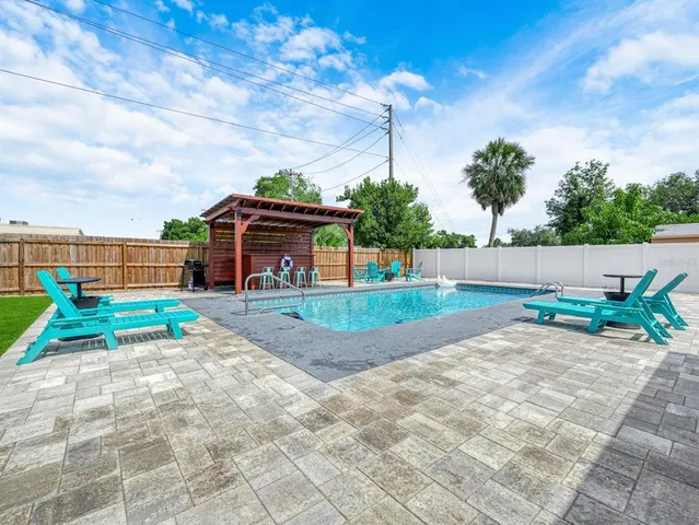a kitchen with stainless steel appliances kitchen island granite countertop a sink stove and refrigerator