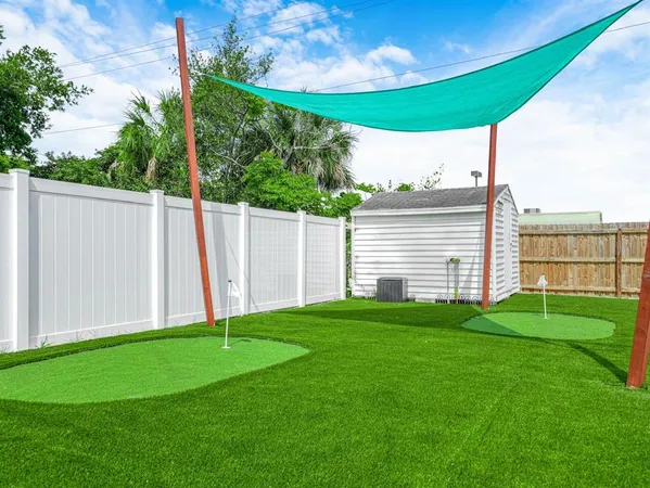 a kitchen with granite countertop a sink cabinets and wooden floor