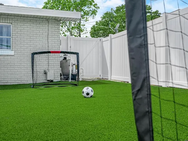 a view of play room with entryway and wooden floor