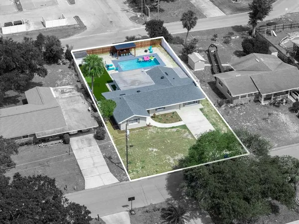 a kitchen with a table chairs and wooden floor