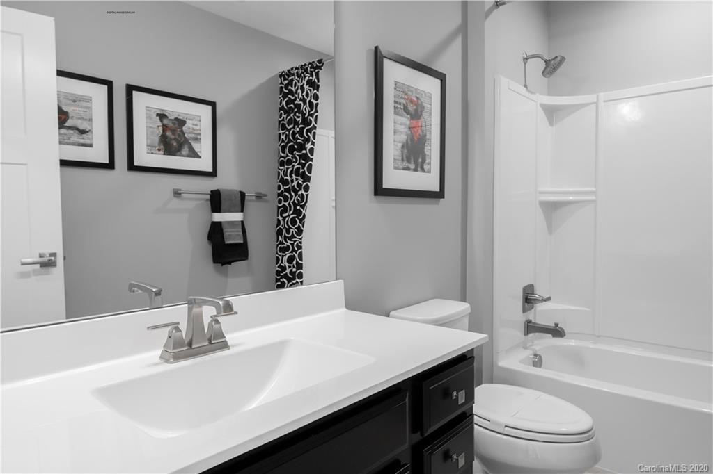 7126 Messina Road, Unit 134 Indian Land, SC 29707 - Photo 7 of 11 a bathroom with a sink a toilet and shower