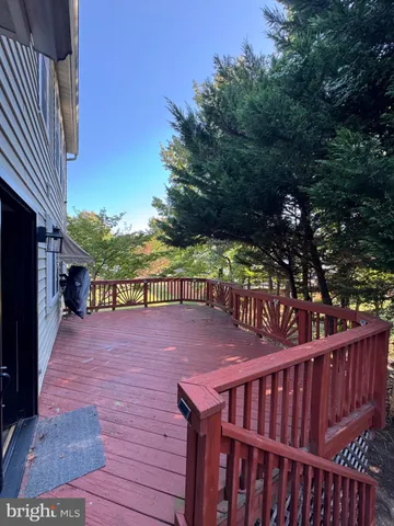 an open kitchen with wooden floor and large window