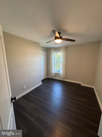a bathroom with a sink a toilet a mirror and shower