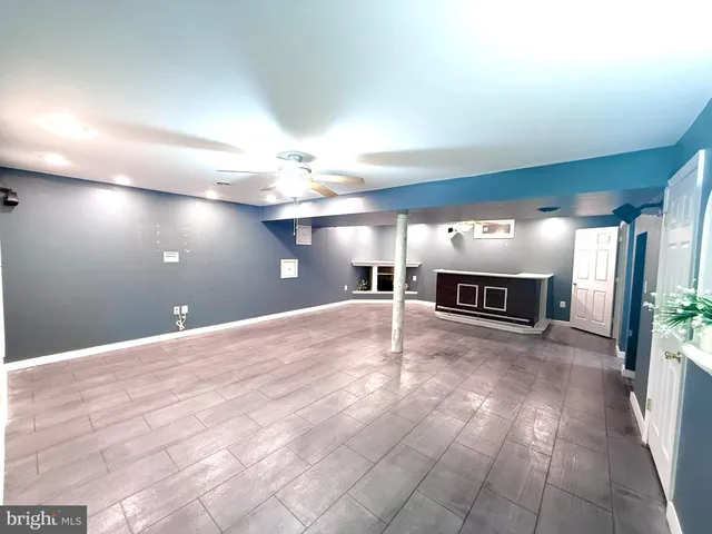 a kitchen with stainless steel appliances granite countertop a refrigerator a sink dishwasher a stove and a dining table with wooden floor