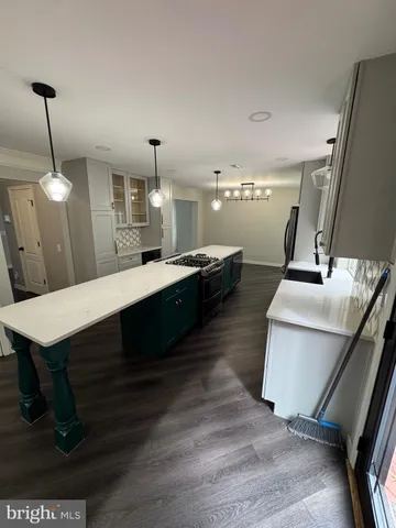 a bathroom with a sink a toilet a mirror and shower