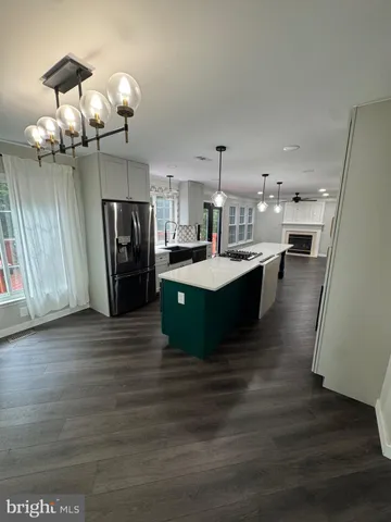 a view of an empty room and window and wooden floor