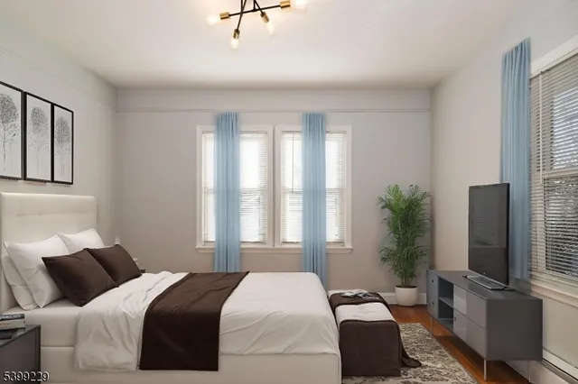 a bedroom with a balcony a bed and a flat screen tv