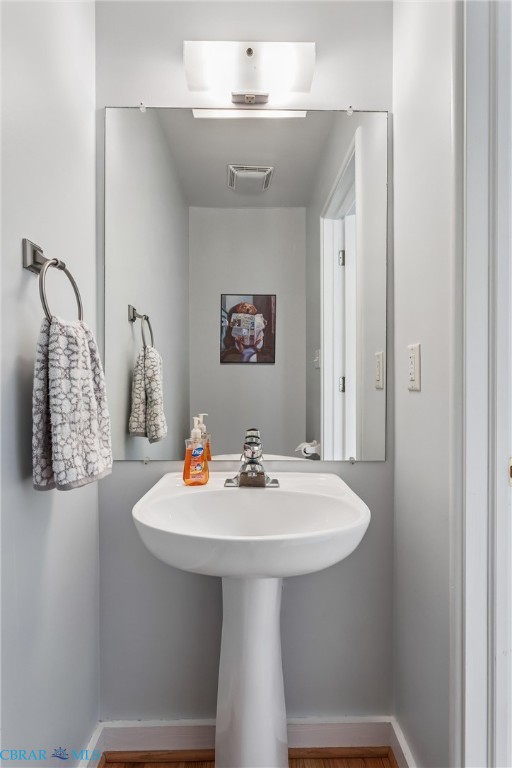 172 Sturgeon Creek Road Deltaville, VA 23043 - Photo 22 of 50 Half Bathroom featuring baseboards and wood finished floors