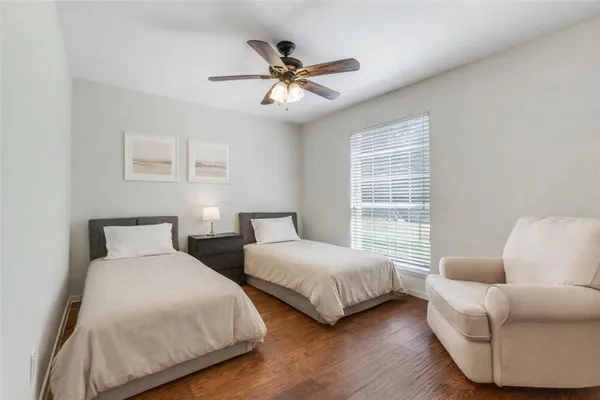 a bedroom with two beds and a couch