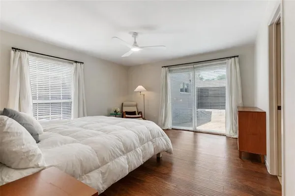 a bedroom with a large bed and a large window