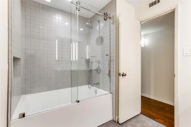 a bathroom with a bathtub and a shower