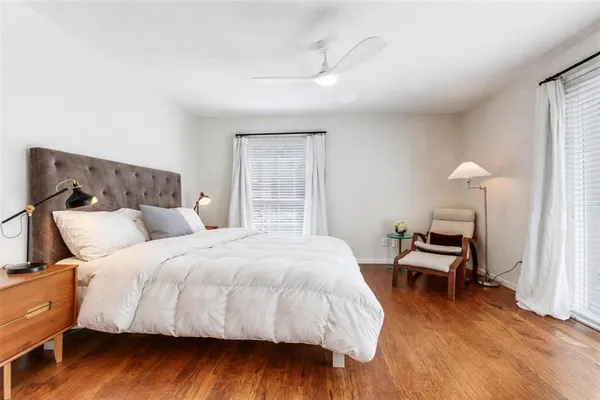 a bedroom with a bed and a lamp