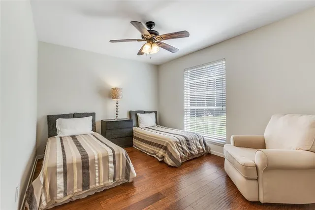 a bedroom with two beds and a couch