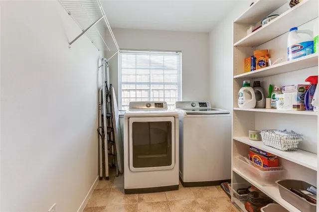 a utility room with sink dryer and washer