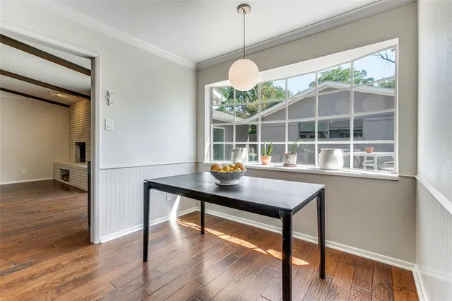 a room with wooden floor and a large window