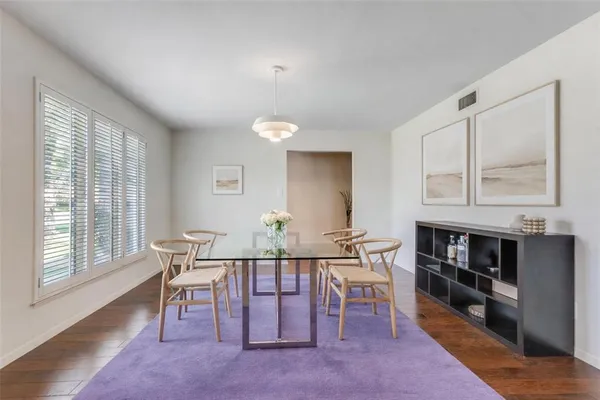 a view of a dining room with furniture and a window