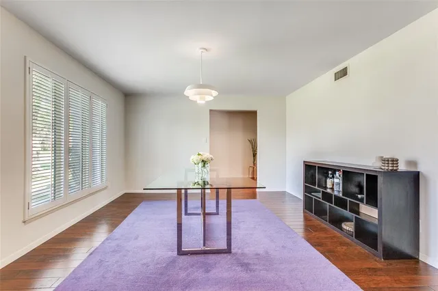 a living room with furniture and a book shelf