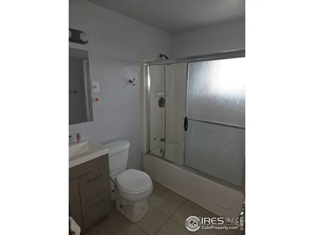 a bathroom with a toilet a sink and shower