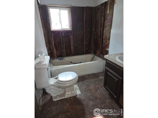 a bathroom with a toilet a sink and bathtub