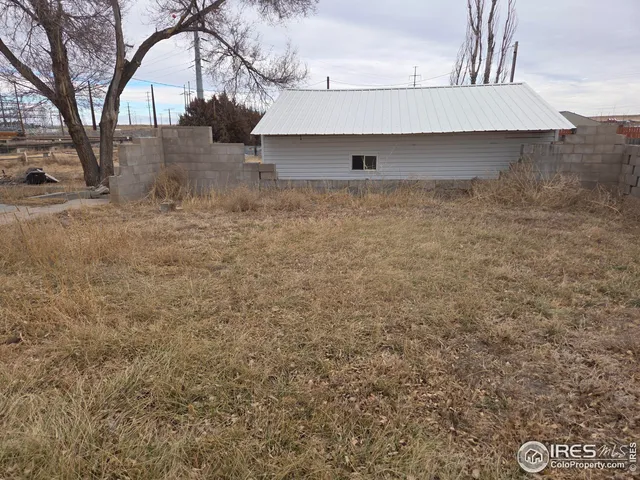 a view of a backyard with large trees