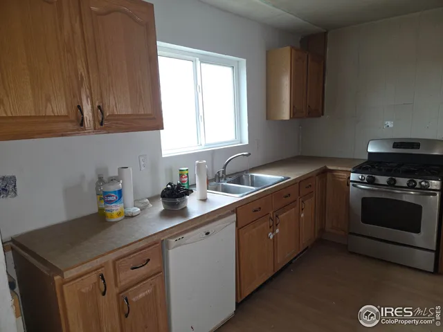 a kitchen with a sink cabinets and a window