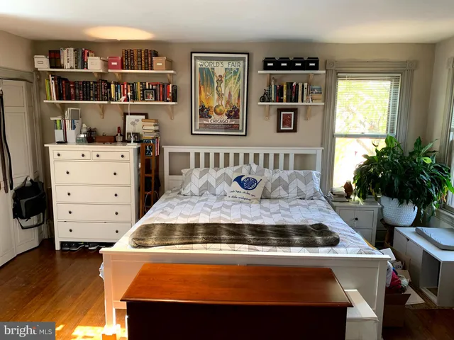 a living room with furniture and a book shelf