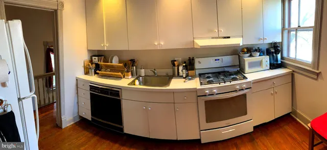 a kitchen with stainless steel appliances granite countertop a stove a refrigerator and a stove