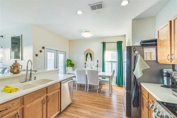 a kitchen with sink cabinets and wooden floor