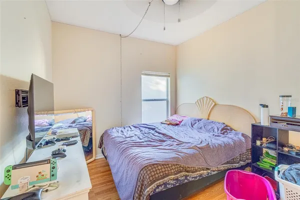 a bedroom with a bed and a chandelier