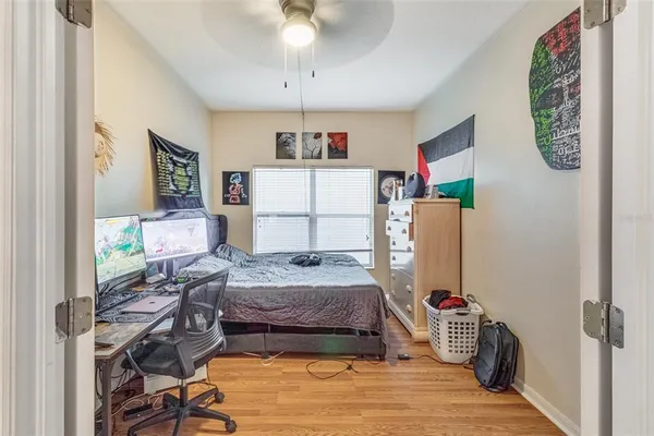 a bedroom with a bed and a desk