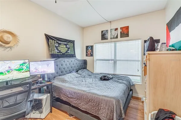 a bedroom with a large bed and a chandelier