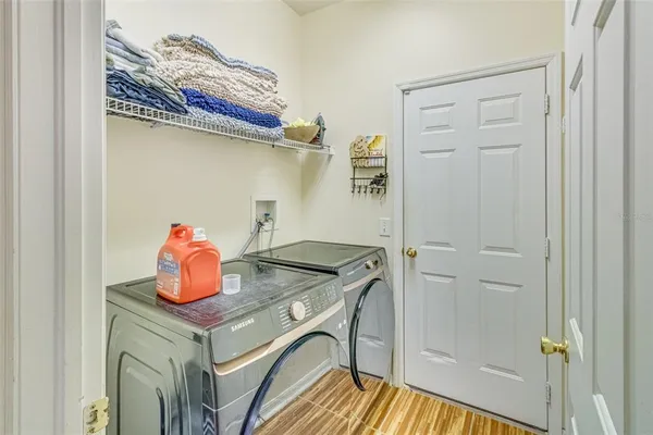 a living room with a large window and furniture