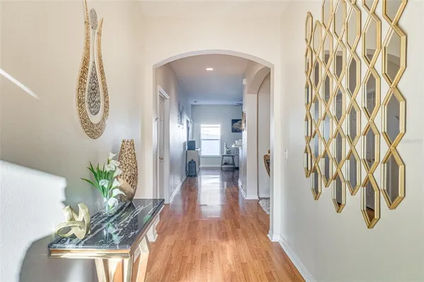 a view of a hallway with wooden floor