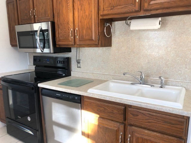 55 Balboa Drive Springfield, MA 01119 - Photo 8 of 29 a kitchen with a sink cabinets and stainless steel appliances