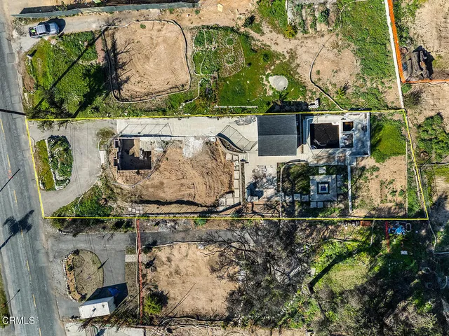 an aerial view of a house with outdoor space