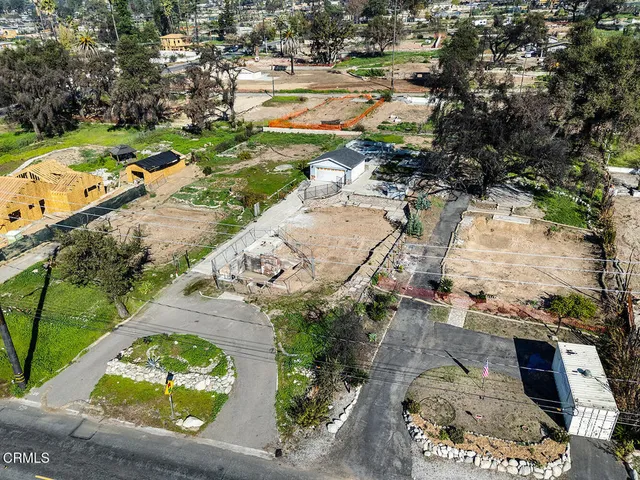 an aerial view of a residential houses with outdoor space